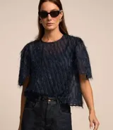 Blusa de chiffon color celeste, con cuello redondo, mangas cortas con fruncidos en los hombros y textura con felpas.