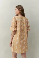 Vestido corto blanco de algodón con bordado artesanal tipo paisley. Presenta escote en V y mangas 3/4 con elástico en el puño.