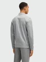 Polo de manga larga gris de algodón interlock con cuello clásico y tapeta de dos botones.