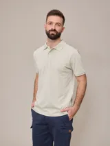 Remera polo de piqué color verde claro, con cuello clásico y mangas cortas. Presenta un pequeño logo bordado en el pecho. Corte recto.