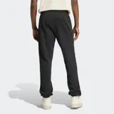 Pantalón de jogging negro Adidas de corte ceñido, confeccionado en felpa francesa. Cuenta con cintura elástica con cordón ajustable, bolsillos laterales, puños acanalados y logo del Trifolio en la pierna.