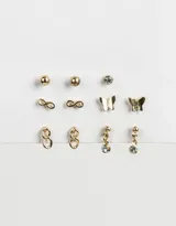 Set de seis pares de aros pasantes dorados con diferentes diseños: esferas, símbolo de infinito, strass, mariposas y eslabones.