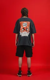 Remera negra de manga corta con cuello redondo y calce oversize. Estampado frontal con Mickey Mouse en un diseño gráfico con detalles en naranja.