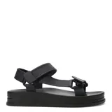 Sandalias de plataforma plana color beige con tiras anchas cruzadas sobre el empeine.