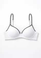 Soutien blanco con copas preformadas y aros. Los bordes de las copas y los tirantes son de microfibra con estampado de puntos negros.