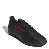 Championes de fútbol 5 en color negro, diseñados para canchas de césped artificial, con lengüeta perforada y forro suave para mayor confort.