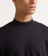 Remera de manga larga confeccionada en tejido de punto de algodón, con cuello tipo mockneck y diseño de hombros caídos.