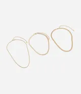Collar dorado con tres cadenas de diferentes diseños: una de eslabones gruesos, una de eslabones pequeños y una de eslabones tipo serpiente.