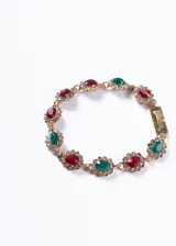 Pulsera dorada con eslabones de bronce y cristales rojos, verdes y blancos engarzados en forma floral.