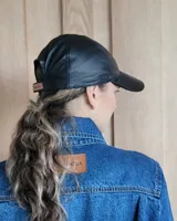 Gorra tipo béisbol color marrón, confeccionada en cuero gamuzado.