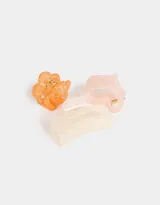 Set de tres broches para el pelo con forma de corazón rosa, flor naranja y broche rectangular blanco.
