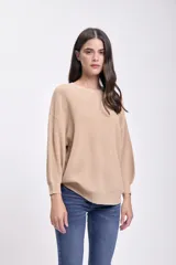 Buzo de punto color beige con mangas globo y corte holgado.