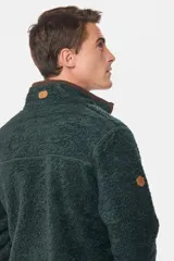 Campera de abrigo azul de corderito con interior de polar y cierre frontal. Presenta un bolsillo de tela lisa en el pecho y bolsillos laterales con cierre.