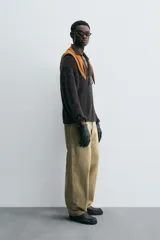 Sweater tipo polo color gris oscuro, de punto con textura, corte regular fit, cuello solapa con abertura frontal, manga larga y terminaciones en rib.