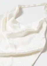 Top color blanco con estampado de lunares, de tejido jacquard satinado, con cuello drapeado y espalda descubierta con cierre de lazo.
