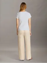 Remera blanca de algodón con cuello redondo, mangas cortas y logo de Calvin Klein Jeans estampado en el pecho.