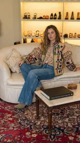 Chaqueta color marfil con bordados florales en azul y terracota, de corte recto y mangas largas.