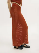 Falda larga de tejido calado color ladrillo, con cintura elástica.