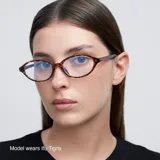 Lentes con montura ovalada negra de acetato y lentes transparentes con filtro de luz azul y protección UV400. Diseñados para comodidad y durabilidad.