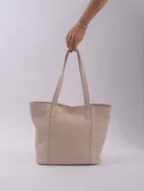 Bolso tote color beige de cuero, con broche, bolsillo interior y porta llaves.