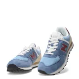 Championes urbanos New Balance modelo 574, color azul claro y azul medio, con detalles en beige, burdeos y blanco. Confeccionados en gamuza y malla, con logo "N" característico en los laterales y entresuela ENCAP.
