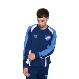 Buzo azul marino de algodón con recortes en blanco y celeste en mangas y hombros. Logo de Umbro bordado en blanco y escudo del Club Nacional de Football estampado en el pecho.