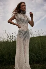 Vestido maxi blanco sin mangas con detalle de encaje y corte fluido.