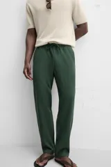 Pantalón largo verde oscuro de algodón con textura, corte recto y cintura elástica ajustable con cordón.