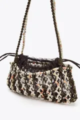 Bolso mini de hombro trenzado con combinación de colores y materiales en el cuerpo. Asa de hombro y bolsa interior de mesh con cierre fruncido.