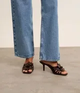 Sandalia mule color marrón con punta cuadrada, tira con flor y aplicación de strass, y tacón fino alto.