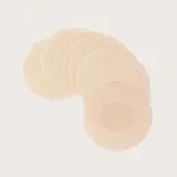 Parches de tela color beige para cubrir los pezones. Son reutilizables.
