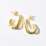 Caravanas de bronce bañadas en oro con diseño curvado y cerradura tipo gancho.