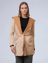 Chaqueta color beige de suede, marca Joan Vass. Cuello solapa, delantera con bolsillos. Cintura con pasadores y lazo de ajuste.
