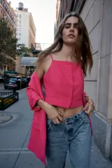 Blazer rosa pálido con cuello solapa y hombreras. Mangas 3/4 con trabilla y botón dorado. Bolsillos delanteros con solapa.