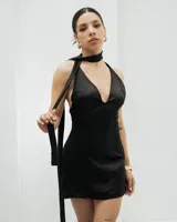 Vestido corto negro de seda con escote halter pronunciado y espalda descubierta. Incluye lazo al cuello.