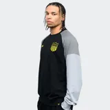 Buzo negro con mangas grises, cuello redondo y puños y cintura acanalados. Presenta el escudo del Club Atlético Peñarol y el año de fundación bordados en amarillo.