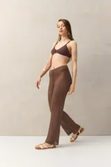 Pantalón de crochet color crudo, con corte acampanado, cintura con cordón ajustable y diseño calado.