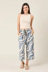 Pantalón palazzo corto con estampado de cebra en tonos verde y beige. El pantalón es tipo culotte, con cintura elastizada y cordón ajustable.