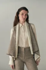 Chaleco marrón con diseño a cuadros, solapas anchas y bolsillos laterales.