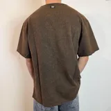Remerón verde militar de corte oversize y tela rústica.