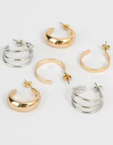 Set de tres pares de aros: un par de argollas gruesas doradas, un par de argollas triples plateadas y un par de argollas planas doradas.