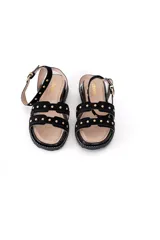 Sandalias negras de gamuza con plataforma corrida forrada y tachas doradas.