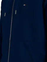 Buzo con capucha y cierre de cremallera Tommy Hilfiger, color azul marino, con logo bordado en el pecho y bolsillos laterales.