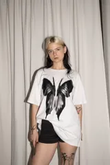 Remera de algodón blanco con estampado serigráfico de mariposa en negro.