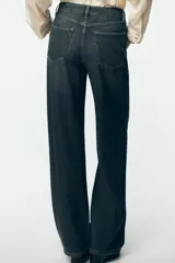 Pantalón de jean de tiro alto color gris oscuro, corte recto, con bolsillos delanteros y traseros. Cierre frontal con cremallera y botón.