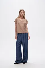 Pantalón azul de lyocell, de corte ancho y tiro alto, con cintura elastizada y bolsillos laterales.