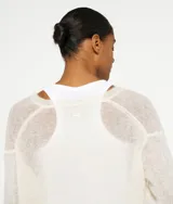 Suéter negro de punto fino con cuello en V y corte holgado, confeccionado en mezcla de lana de alpaca.