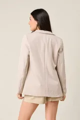 Blazer negro de corte sastre, con solapas de muesca, cierre frontal con un botón y bolsillos delanteros con solapa.