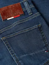 Pantalón de jean azul de corte recto, con efecto desgastado, diseño de cinco bolsillos y cierre de botón y cremallera.