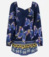 Vestido corto de viscosa y lino con estampado de mariposas, escote en pico y mangas largas abullonadas.